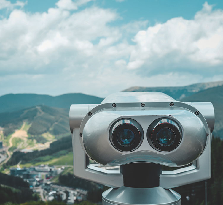 Image of a metal binocular viewer on a mountain viewpoint